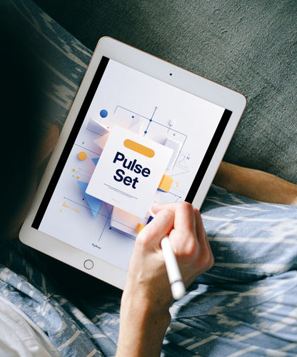 A person lying on a couch holds a white tablet with a stylus, showing a digital interface labeled 'Pulse Set' on the screen.